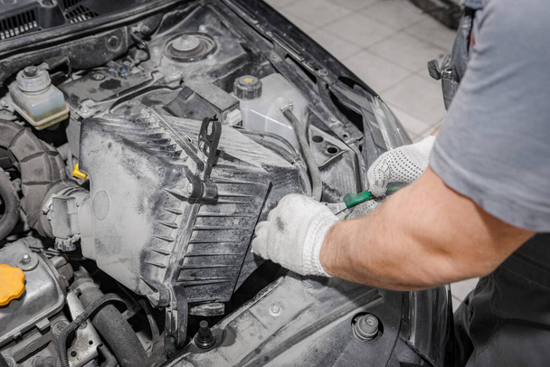 Mechanic repairing engine on a car using wrench. Close up of hands - Fotografie, Obrázek
