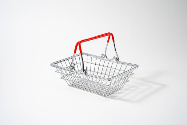 Shopping cart with raised handles on white isolated background, customer, shopper convenience - Фото, изображение