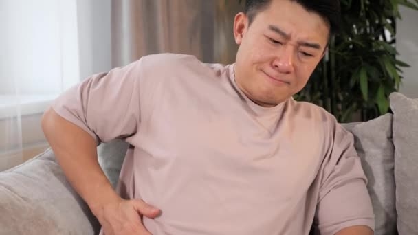 Adult Chinese guy feeling acute liver pain, gallbladder inflammation, hepatitis. - Filmati, video