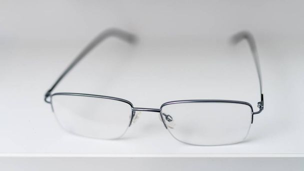 Corrective eyesight lenses. Close up of eyeglasses on the table. - Fotó, kép