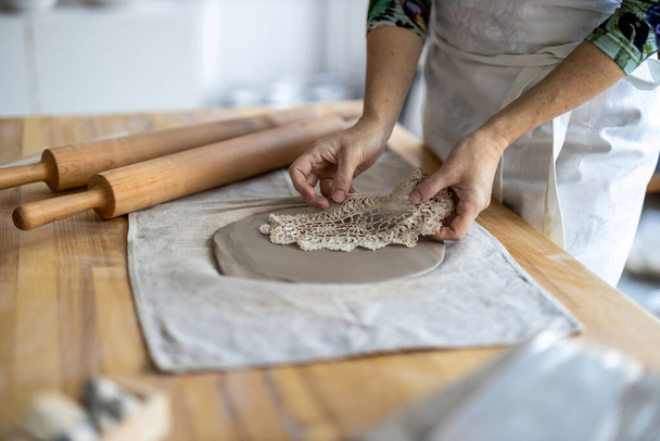 Close-up of craftswoman working on her pottery in workshop - Φωτογραφία, εικόνα
