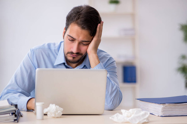 Young male employee suffering at workplace - Photo, Image