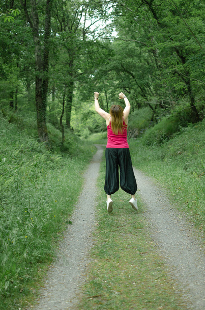 young woman jumping in the forest - Valokuva, kuva