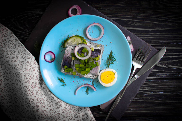 herring sandwich blue onion on wooden background - Photo, Image