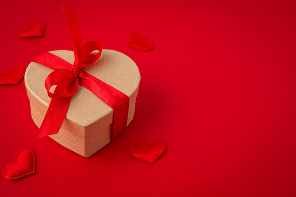 Ajándék doboz szív alakú íj piros háttér, Szent Valentin-nap - Fotó, kép