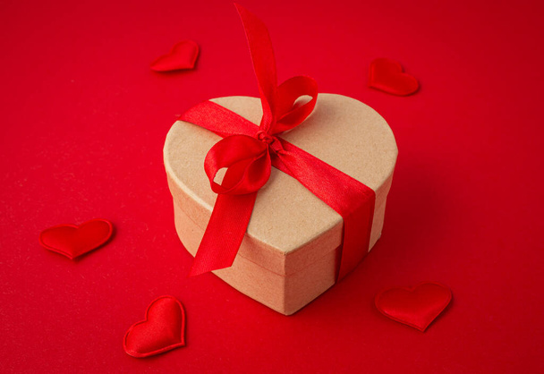 Gift boxes in heart shape with bow on red background, Saint Valentine Day - Fotoğraf, Görsel