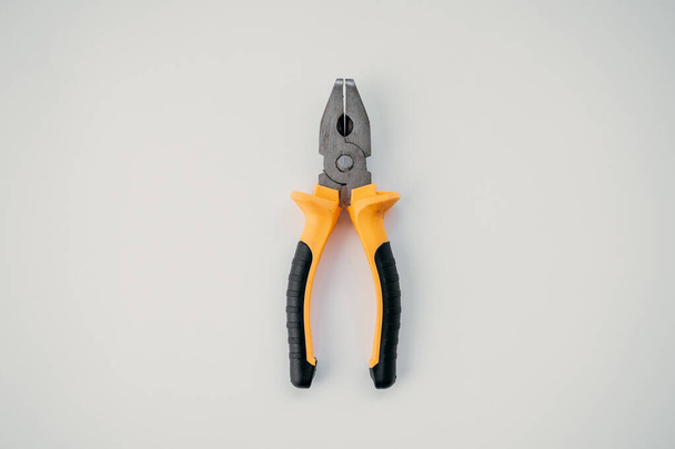 Closed pliers lie on white isolated background, tool for repair work - Photo, Image
