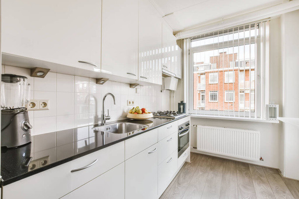 Cozy kitchen with white kitchen unit - Photo, Image