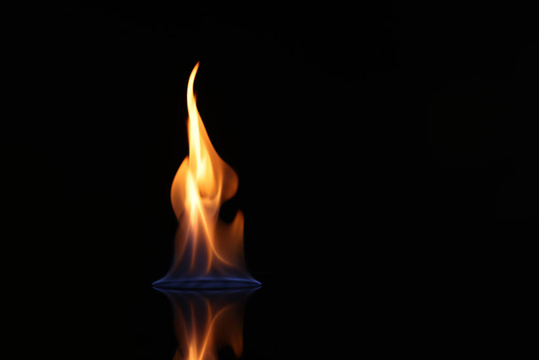 Beautiful view of flaming vodka on black background - Foto, Bild