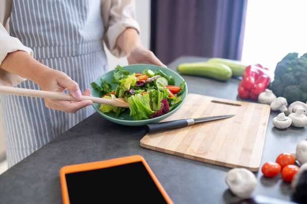 Woman cutting vegetables on a cutting board - Photo, Image