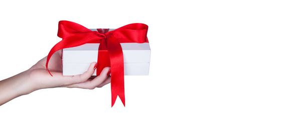 Gift box in wrapping paper with satin ribbon. Merry Christmas holiday concept. - Fotoğraf, Görsel