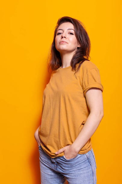 Joyful person standing over orange background in studio - Photo, Image