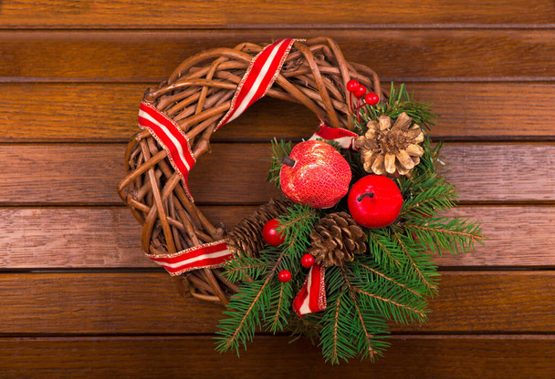 green christmas wreath with decorations over wooden background. - Fotó, kép
