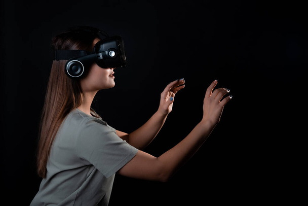 Virtual experience, a young woman using virtual reality glasses, - Foto, immagini