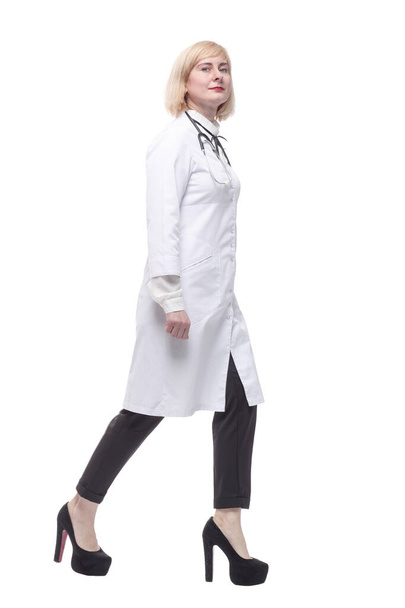 qualified female doctor stepping forward . isolated on a white background. - Zdjęcie, obraz