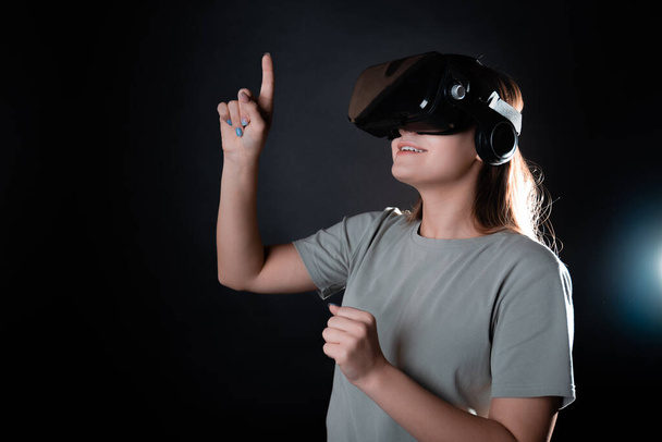 Virtual experience, a young woman using virtual reality glasses, - Foto, afbeelding