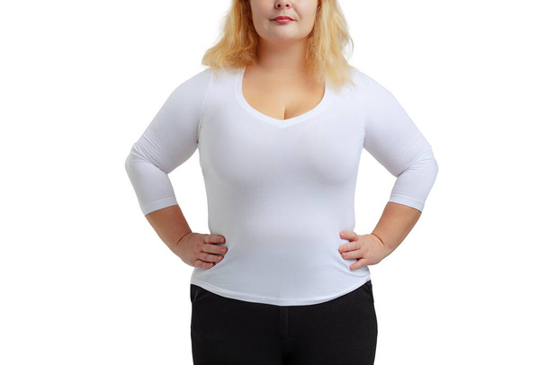 Cropped image of plus-size woman wearing white t-shirt and jeans posing isolated on white studio background. - Фото, изображение