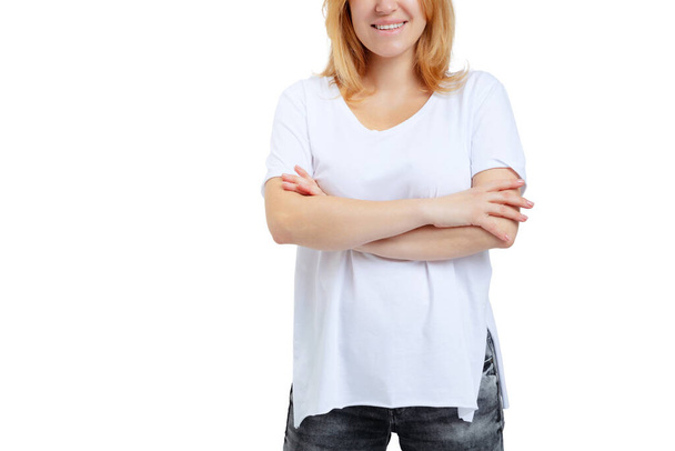 Cropped image of plus-size woman wearing white t-shirt and jeans posing isolated on white studio background. - Zdjęcie, obraz