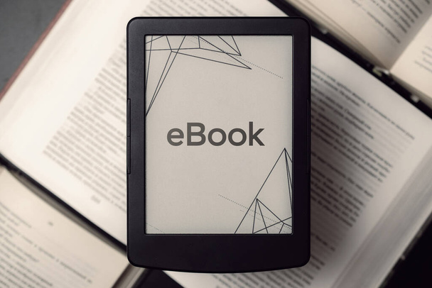 Lezers. Digitaal e-book, bibliotheeklezer tablet met boeken over donkere achtergrond. E-book, e-learning elektronisch internet mobiliteitsconcept - Foto, afbeelding
