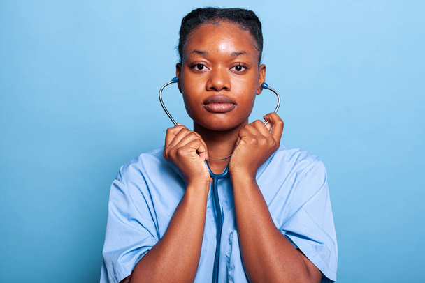 Portrait african american specialist therapist nurse putting medical stethoscope - Foto, immagini