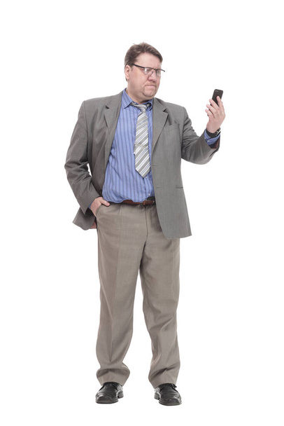 in full growth. serious business man with a smartphone. - Photo, Image