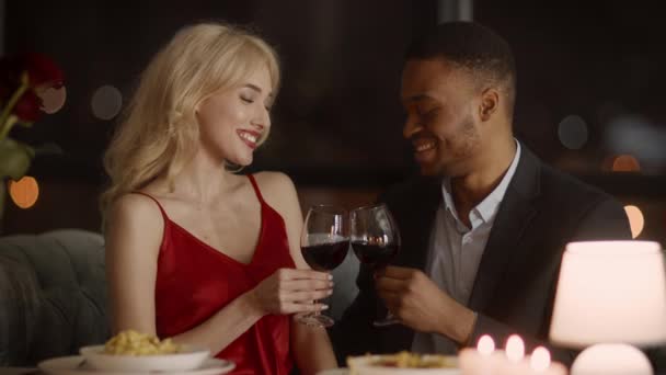 Pár zvonění brýle pití vína slaví Valentýna v restauraci - Záběry, video