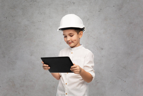 little boy in construction helmet with tablet pc - 写真・画像