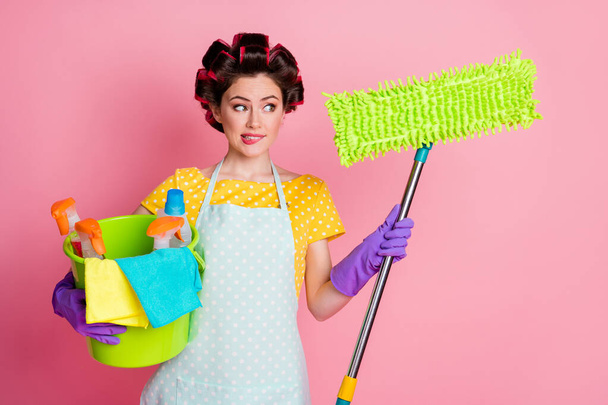 Portrait of uncertain girl hold window washer mop bucket spray look think thoughts isolated over pastel color background - Фото, зображення