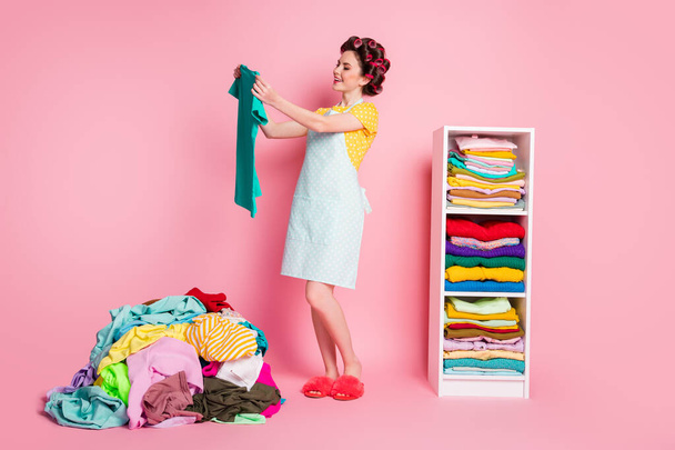 Full length body size view of nice attractive cheery maid choosing wear things making comfort organizing isolated pink pastel color background - Foto, afbeelding