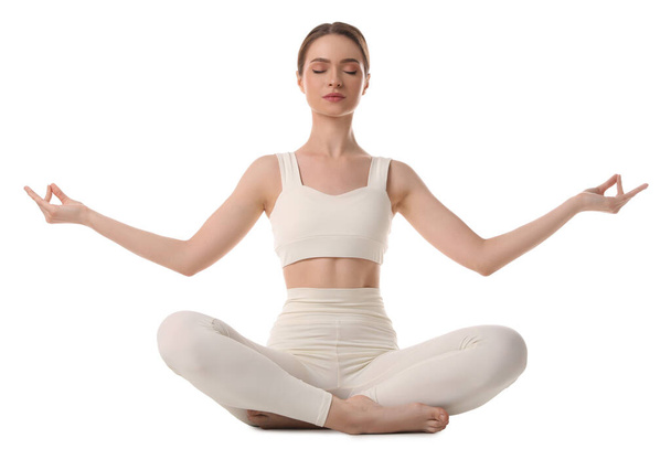 Beautiful young woman meditating on white background - Фото, изображение