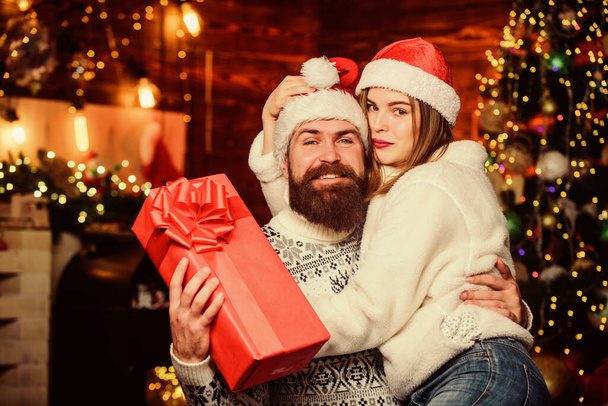 Happy new year. Bearded man and woman. Cheerful mood. Couple in love enjoy christmas holiday celebration. Christmas time. Lovely married couple cuddle christmas tree background. Happiness concept - Fotografie, Obrázek