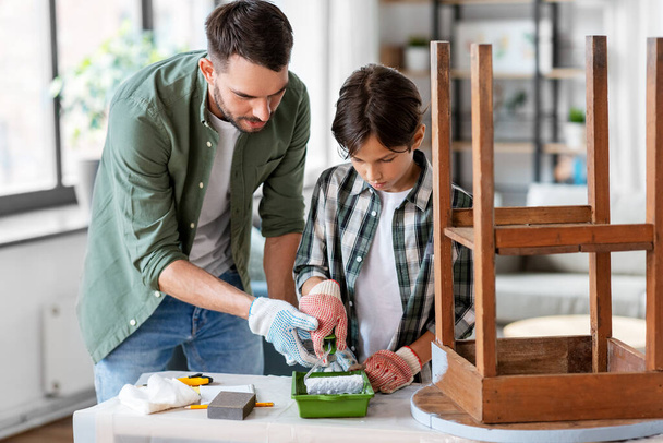 father and son painting old table in grey color - Photo, Image