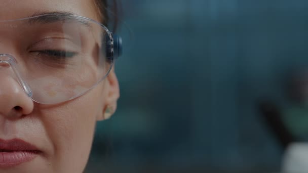Woman scientist wearing protective glasses with virtual reality - Footage, Video