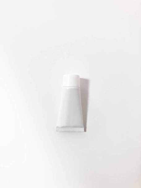 Beautiful tubes on a beautiful white table. No labels. For cosmetics. - Foto, afbeelding