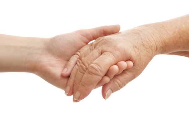 Young and elderly women holding hands together on white background, closeup - Foto, Bild