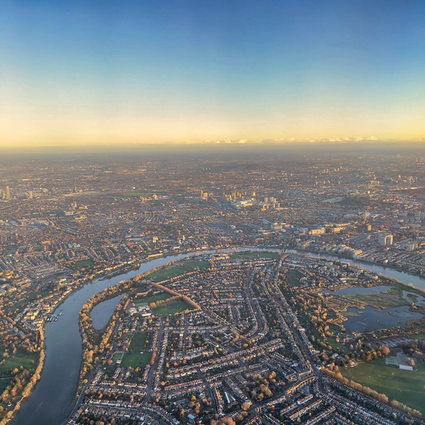 Aerial view of London skyline taken early morning with thick fog envoloping the city with view of river Thames, and many London landmarks. - Photo, Image