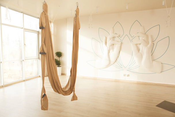 Aerial yoga hammock hanging at empty yoga studio, copy space - Photo, Image