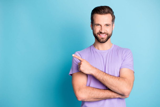 Photo of young attractive man happy smile point finger empty space advert recommend choose isolated over blue color background - Zdjęcie, obraz