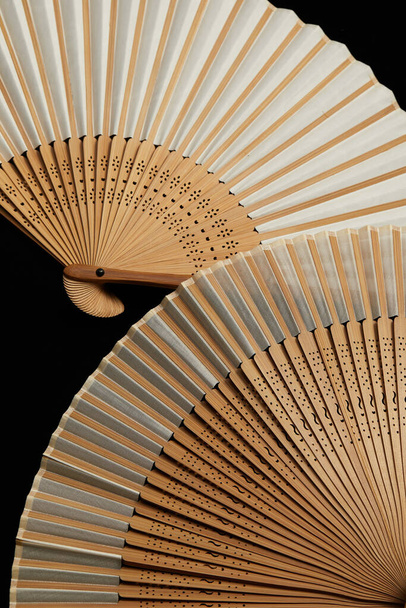 Some hand fans elegantly placed on a black background - Фото, изображение