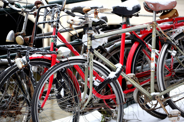 A closeup shot of snowy bicycles on a bridge in Amsterdam - Photo, Image
