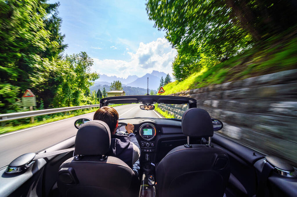 Drivers hands on a steering wheel of a convertible car. Road trip on the Italians road. - Zdjęcie, obraz
