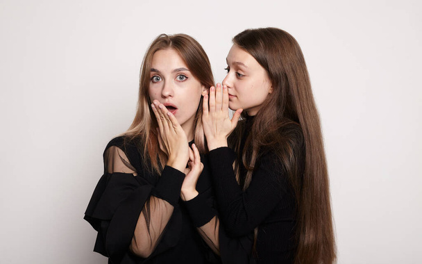 two girls are secret on a light background - Photo, Image