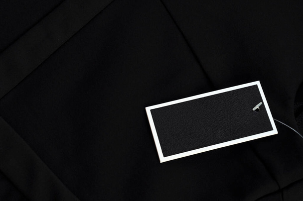 Black business dress code background with a label close up - Φωτογραφία, εικόνα