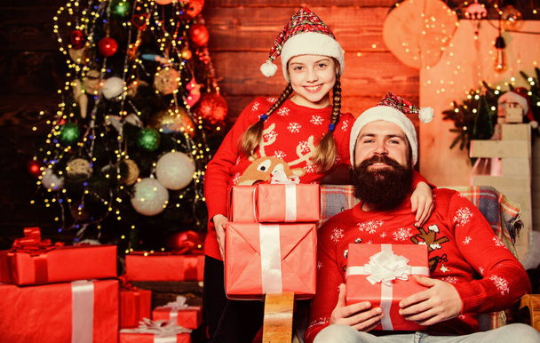 Spend time with your family. Father bearded man and daughter near christmas tree. Happy holidays. Dad and child opening christmas gifts. Favorite childhood memories of christmas. Happiness and joy - Photo, Image