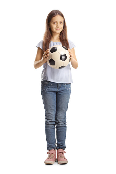Full length portrait of a girl in jeans holding a football isolated on white background - Foto, Bild