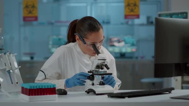 Προσωπογραφία χημικού που εργάζεται με μικροσκόπιο στο εργαστήριο - Πλάνα, βίντεο