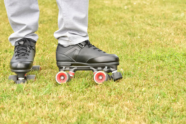 Men's roller skates on a grass during leisure, recreation and summer entertainment. - Photo, image