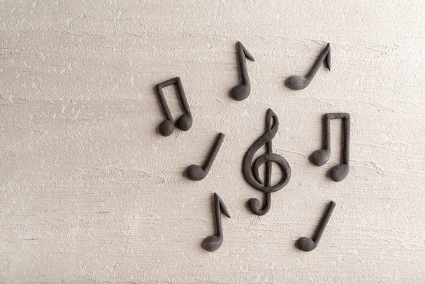 Treble clef and musical notes on beige background. Violin key. Copy space. Top view - Foto, immagini