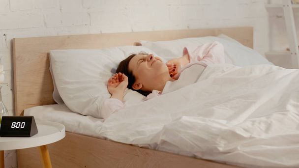 Sleepy woman lying on bed in morning  - Foto, Bild
