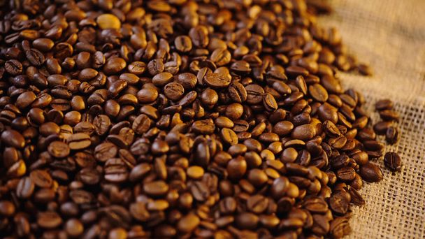 high angle view of roasted coffee beans on canvas - Фото, зображення
